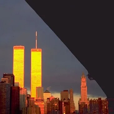 Sunset illuminates the Twin Towers against a dark sky.